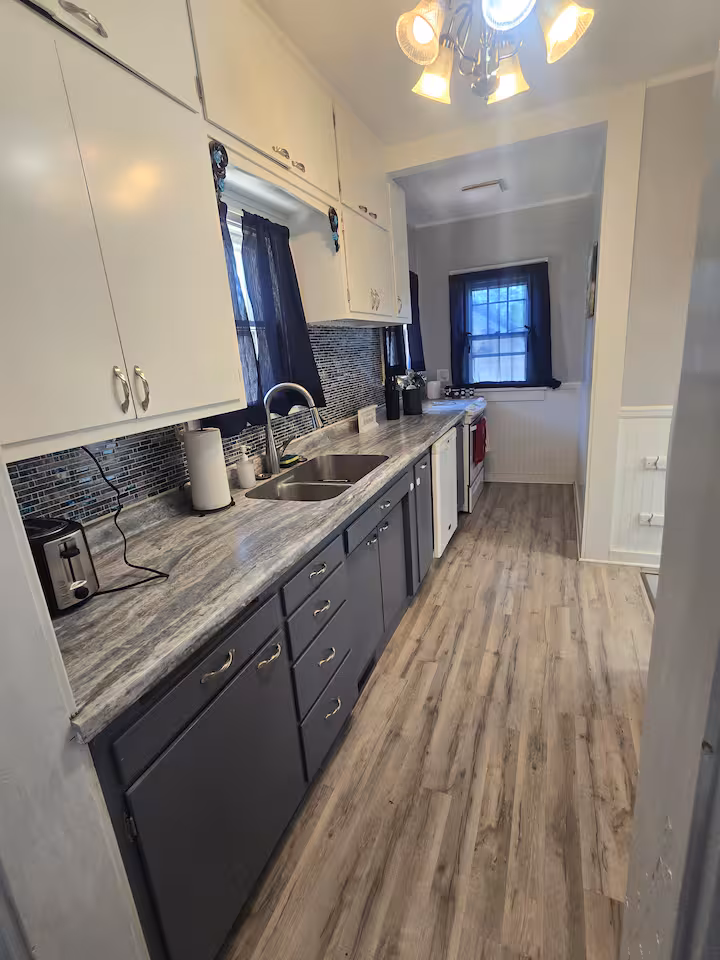 Kitchen sink and cooking area at The Cozy Cottage